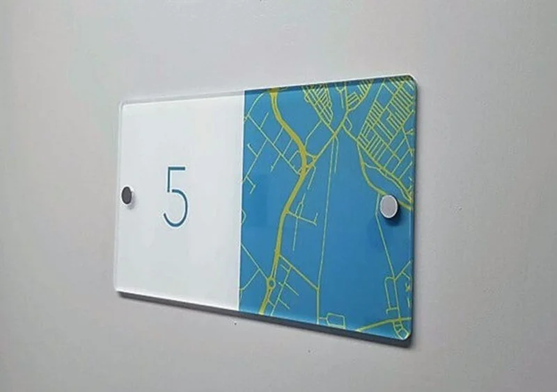 An image of room number directional signage for a school.